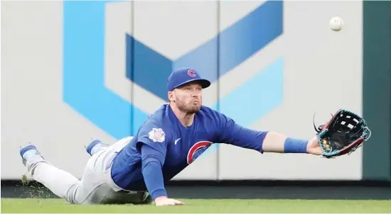  ?? AP PHOTOS ?? ABOVE: The Cubs’ Ian Happ makes a diving attempt to catch a fly to left field in the second inning Friday against the Cardinals. BELOW: Happ smacks an RBI double in the fifth.