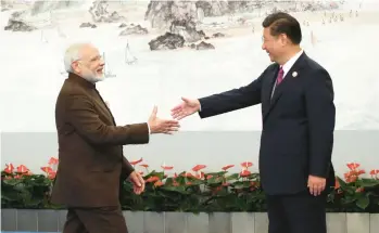  ?? MIKHAIL SVETLOV/GETTY ?? Indian Prime Minister Narendra Modi, left, greets Chinese President Xi Jinping prior to their dinner on Sept. 4, 2017, in Xiamen, China. In 2020, a border clash between the two nations almost led to war.