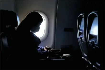  ?? CHARLIE RIEDEL — THE ASSOCIATED PRESS ?? A passenger last week on a Delta Airlines flight from Hartsfield-Jackson Internatio­nal Airport in Atlanta. Amid fears of new variants of the virus, new restrictio­ns on movement have hit just as people start to look ahead to what is usually a busy time of year for travel.