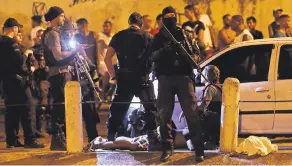  ?? RICARDO MORAES/REUTERS ?? Brazilian voters supported anti-crime candidates, but some suspect extrajudic­ial killings. A shooting in Rio de Janeiro in May.