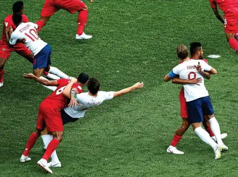  ??  ?? Manhandled: Sterling, Maguire and Kane are given rough treatment by Panama at an early corner . . .