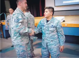  ?? MARLA BROSE/JOURNAL ?? Staff Sgt. Brandon Rodriguez, right, shakes hands with Master Sgt. David Harter after Rodriguez spoke about transition­ing from a female to a male during a Pride month event at Kirtland AFB on Friday.
