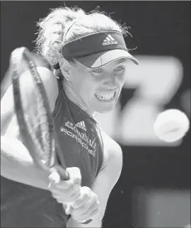  ?? William West AFP/Getty Images ?? ANGELIQUE KERBER of Germany shows intensity while hitting a shot on the way to a 6-1, 6-2 quarterfin­al victory over Madison Keys of the United States.