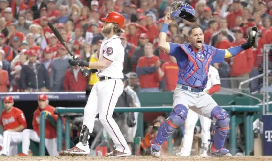 ??  ?? Cubs catcher Willson Contreras begins to celebrate after Bryce Harper strikes out swinging against Wade Davis for the last out of the NLDS on Thursday. | PABLO MARTINEZ MONSIVAIS/ AP