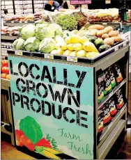  ?? LYNN KUTTER ENTERPRISE-LEADER ?? This stand in the Harps store in Lincoln has locally grown produce, including sweet potatoes, cabbage, squash and tomatoes. Locally grown means the items are grown within 150 to 200 miles of the store.