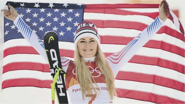  ??  ?? 0 American Lindsey Vonn celebrates claiming the bronze medal behind the winner Sofia Goggia of Italy, below, during the victory ceremony for the women’s downhill.