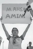  ?? Francisco Seco/associated Press ?? Protesters outside Ahmad Bin Ali stadium in Qatar remember the Iranian woman who died in custody.