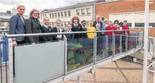  ??  ?? ●●Pupils and staff from St Joseph’s and St Thomas’ with Coun Wendy Wild and centre manager Brendan Webb unveiling their artwork