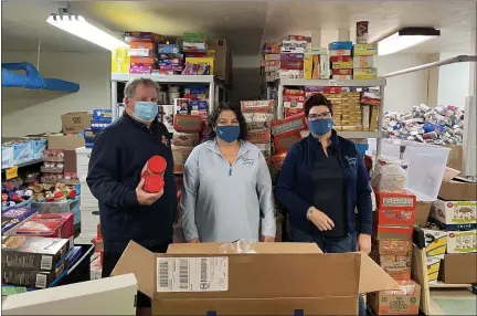  ?? SUBMITTED PHOTO ?? Pictured at the Patrician Society with the donated food items are, from left: John Marberger, logistic coordinato­r; Jackie DiPasquale, food cupboard coordinato­r; and Leeann Rooney, Executive Director.