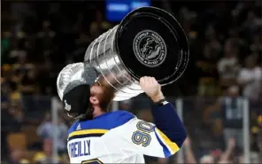  ?? Patrick Smith/Getty Images ?? Ryan Reilly of the St. Louis Blues kisses the Stanley Cup after his team defeated the Boston Bruins in seven games.