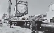  ??  ?? Navy personnel unload liquid medical oxygen tanks supplied by French company as Covid relief to India, in Mumbai on May 10.