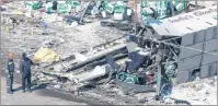  ?? CP PHOTO ?? Cargo carried by a tractor trailer and hockey equipment bags are strewn around the site of Friday’s crash that involved the Humboldt Broncos’ team bus.