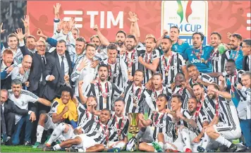  ??  ?? Juventus players in a jubilant mood with the trophy after winning the Italian Tim Cup (Coppa Italia) final in Rome.