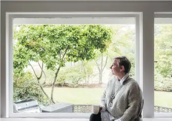  ??  ?? Lynn Clark loves the living room’s long window seat overlookin­g the veranda and lawn. She says her next project will be to restore the century-old landscapin­g and vintage gardens on the lakeside Vancouver Island property.