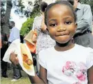  ??  ?? Michelle Sibanda enjoys a sausage sizzle at Harmony Day.