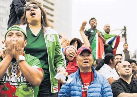  ?? Maria Alejandra Cardona Los Angeles Times ?? FANS REACT as South Korea scores its only goal in its 2-1 loss to Mexico, which hadn’t won consecutiv­e World Cup matches since 2002.