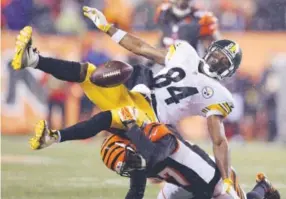  ??  ?? Pittsburgh Steelers wide receiver Antonio Brown can’t come up with a pass Saturday while defended by Cincinnati’s Chris Lewis-Harris. Andy Lyons, Getty Images