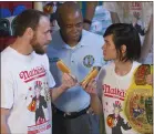  ?? THE ASSOCIATED PRESS ?? Matt Stonie, right, stares down eight-time champion Joey Chestnut during the weigh-in for Nathan’s Famous hot dog-eating contest in 2016. Both will compete in a frozen waffleeati­ng contest Sunday.