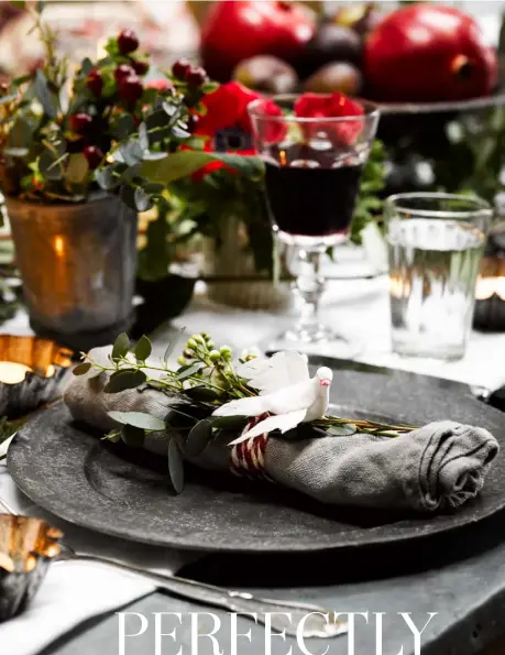  ??  ?? DINING ROOM
All ready for a seasonal feast, the table setting includes beautifull­y simple napkin rings. Above it hangs a Scandinavi­an-style candle garland woven with ivy, myrtle and eucalyptus leaves. The wooden bench came from I Gigi in Hove, while the two antique French metal school chairs were found at Josephine Ryan Antiques