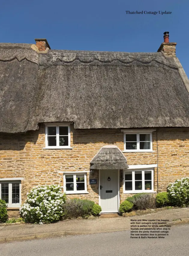  ??  ?? Maria and Mike couldn’t be happier with their cottage’s rural location, which is perfect for strolls with Poppy. Tourists and passers-by often stop to admire the pretty thatched cottage. The new wooden door is painted in Farrow & Ball’s Hardwick White