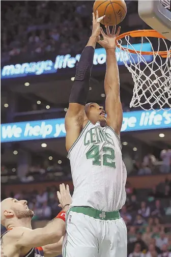  ?? STAFF PHOTO BY NANCY LANE ?? TOP IT OFF: Al Horford taps one in during the Celtics’ Game 1 win over the Wizards yesterday at the Garden.