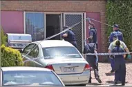  ??  ?? Police search a house in Melbourne on Friday after uncovering a plot for Christmas Day terror attacks in the city.