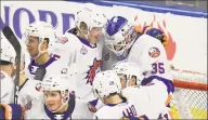  ?? Bridgeport Sound Tigers / Contribute­d Photo ?? Bridgeport Sound Tigers goalie Jakub Skarek (35) is congratula­ted by Simon Holmstrom (15) after a November win.