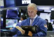  ?? RICHARD DREW — THE ASSOCIATED PRESS ?? Trader Timothy Nick works on the floor of the New York Stock Exchange Wednesday.