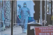  ?? Picture: AFP ?? Forensic investigat­ors work the scene.