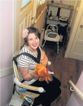  ??  ?? Concerns Jemma White on the stairlift at her home in Fallin