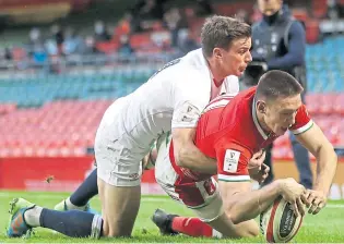  ??  ?? Wales’s Josh Adams dives in to score his side’s first try of the game.