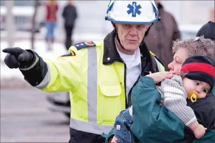  ?? CLIFFORD SKARSTEDT ?? Paramedics respond to a collision involving four pedestrian­s and a vehicle on Thursday at the intersecti­on of Lansdowne St. E. and Ashburnham Dr. Two young children and two adults were sent to hospital.