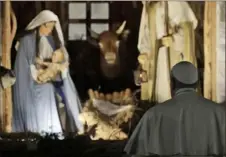  ?? Gregoria Borgia/ Associated Press ?? Pope Francis stops by the Nativity in St. Peter’s Square at the Vatican on Dec. 31. The pope is giving his blessing to new Vatican think tank seeking to prevent the Mafia from exploiting the Virgin Mary’s image. a