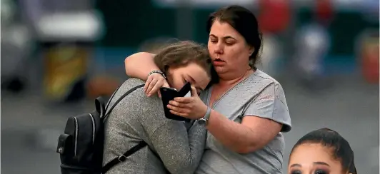  ?? PHOTO: GETTY IMAGES ?? Concert attendees Vikki Baker and her daughter Charlotte, aged 13, leave the Park Inn where they were given refuge after the explosion at Manchester Arena.