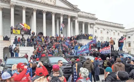  ?? JASPER COLT/USA TODAY ?? Rioters swarm the U.S. Capitol building following a Trump protest in Washington, D.C. on Wednesday.