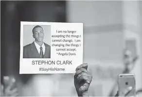  ?? JUSTIN SULLIVAN/GETTY IMAGES ?? A protester holds a photo of Stephon Clark during a Black Lives Matter demonstrat­ion outside Sacramento City Hall.