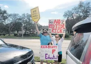  ?? STEVEN LEMONGELLO/ORLANDO SENTINEL ?? Protesters gather outside Gov. Rick Scott’s campaign stop on Tuesday in Orlando.