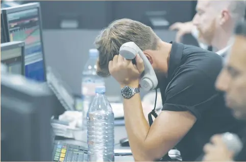  ?? (Toby Melville/Reuters) ?? DEALERS WORK on a trading floor at BGC Partners in London’s Canary Wharf business district yesterday. With equities increasing­ly priced to reflect superior yields versus bonds and drawing investment flows to keep them near record highs, ructions in the...