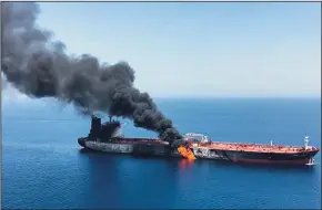  ?? IRANIAN NEWS AGENCY/AFP/GETTY IMAGES ?? Fire and smoke billow from Norwegian owned Front Altair tanker on Thursday after it was allegedly attacked in the Gulf of Oman.