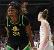  ?? (AP/Jessica Hill) ?? Oregon’s Ruthy Hebard (left) scored 22 points and had 12 rebounds in the Ducks’ 74-56 victory over Connecticu­t on Monday night in Storrs, Conn.