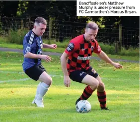  ??  ?? Bancffosfe­len’s Matthew Murphy is under pressure from FC Carmarthen’s Marcus Bryan.