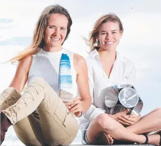  ??  ?? Leisa Russell, left, and Tessa Bergan with the trophies they designed. Picture: JOHN GASS