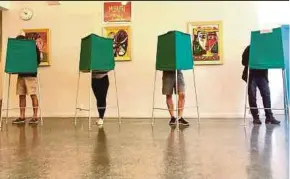  ?? REUTERS PIC ?? People voting in Stockholm, Sweden yesterday.