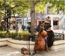  ?? ?? Left: Books and wine are availble for sale at Bad Animal. Right: Jazz musician Kurt Feinberg plays on Pacific Avenue.