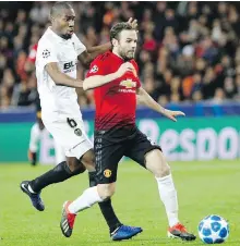  ??  ?? Manchester United’s Juan Mata heads up field with Valencia midfielder Geoffrey Kondogbia in pursuit during action in Valencia, Spain, on Wednesday.