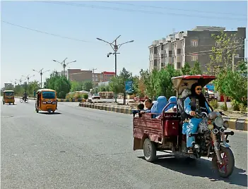  ?? —
AP ?? Afghans travel in motorcycle carts during fighting between Taliban and Afghan security forces in Herat province, west of Kabul on Sunday.