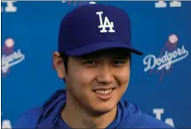  ?? CAROLYN KASTER — THE ASSOCIATED PRESS ?? Los Angeles Dodgers’ Shohei Ohtani, who signed with the team during the offseason, smiles as he speaks during spring training on Friday.