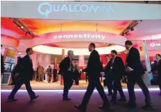  ??  ?? Visitors walk past the Qualcomm stand at the Mobile World Congress in Barcelona, Spain, in this file photo. — Reuters