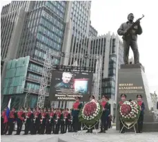  ?? — Reuters ?? Guards of honour stand next to a monument to Mikhail Kalashniko­v, the Russian designer of the AK-47 assault rifle, during its opening ceremony in Moscow on Tuesday.