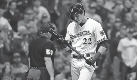  ?? RICK WOOD / MILWAUKEE JOURNAL SENTINEL ?? Milwaukee Brewers star Christian Yelich is frustrated as he walks back to the dugout after striking out in the eighth.